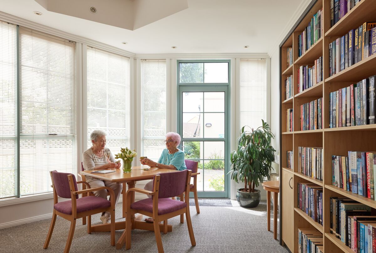 Two ladies enjoying the library at Goodwin Close