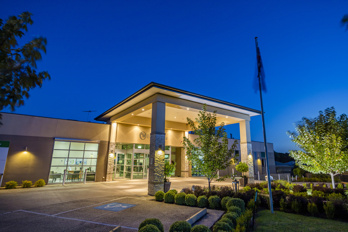 Evelyn Ridge evening photo of well lit main entrance to building from the outside