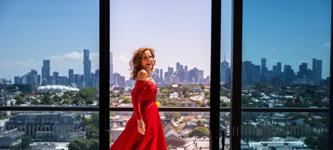 Rhonda Burchmore standing on the terrace of a penthouse at Ardency Kennedy Place
