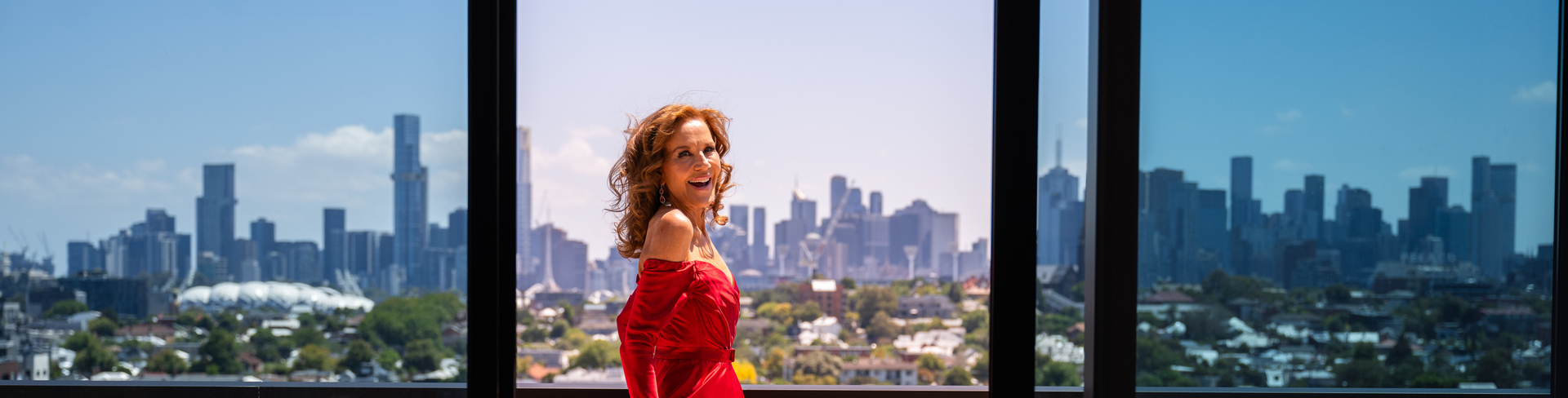 Rhonda Burchmore standing on the terrace of a penthouse at Ardency Kennedy Place