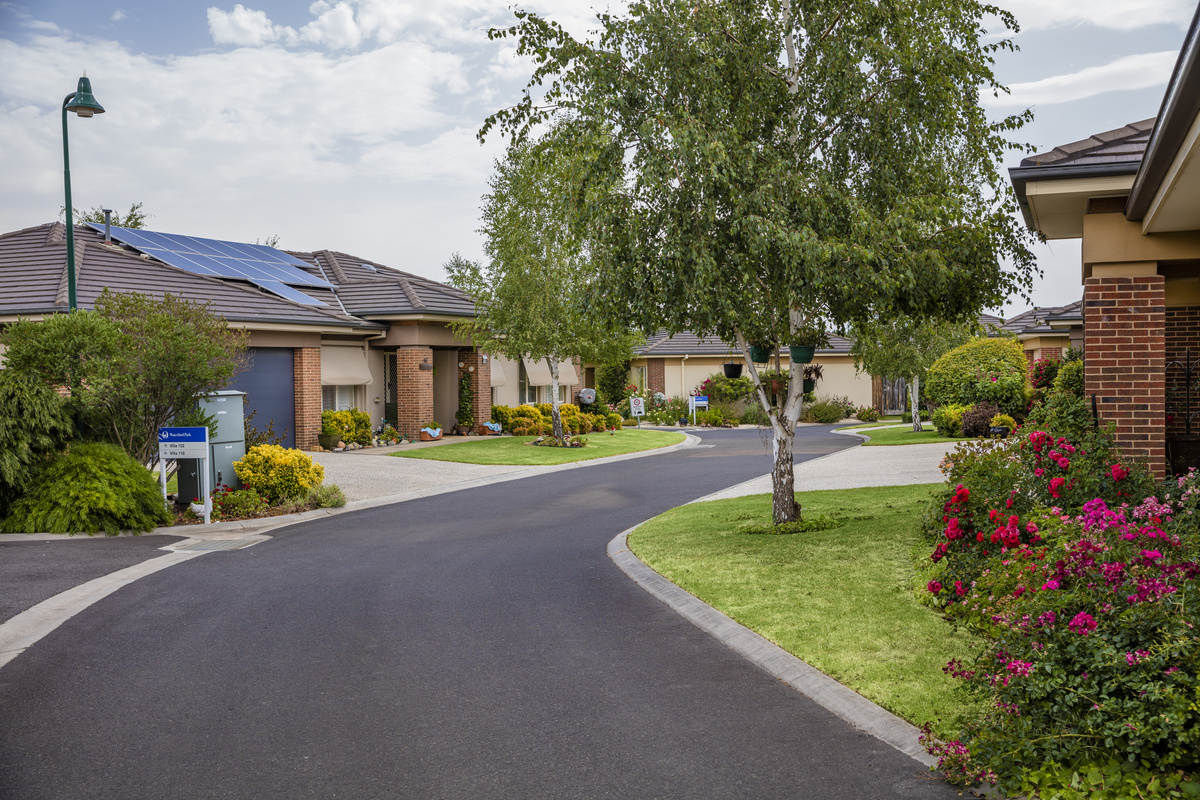 Waterford Park village roadway lined with homes, gardens and lawns