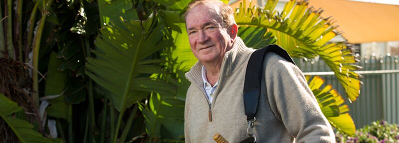 The Village Williamstown resident Frank with a golf bag over his shoulder