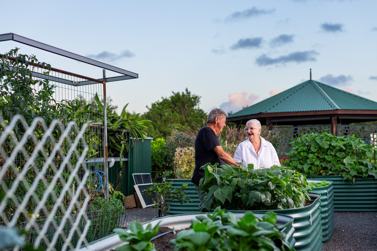 Bellflower retirement village resident David and a neighbour enjoying the communit garden vegetable beds