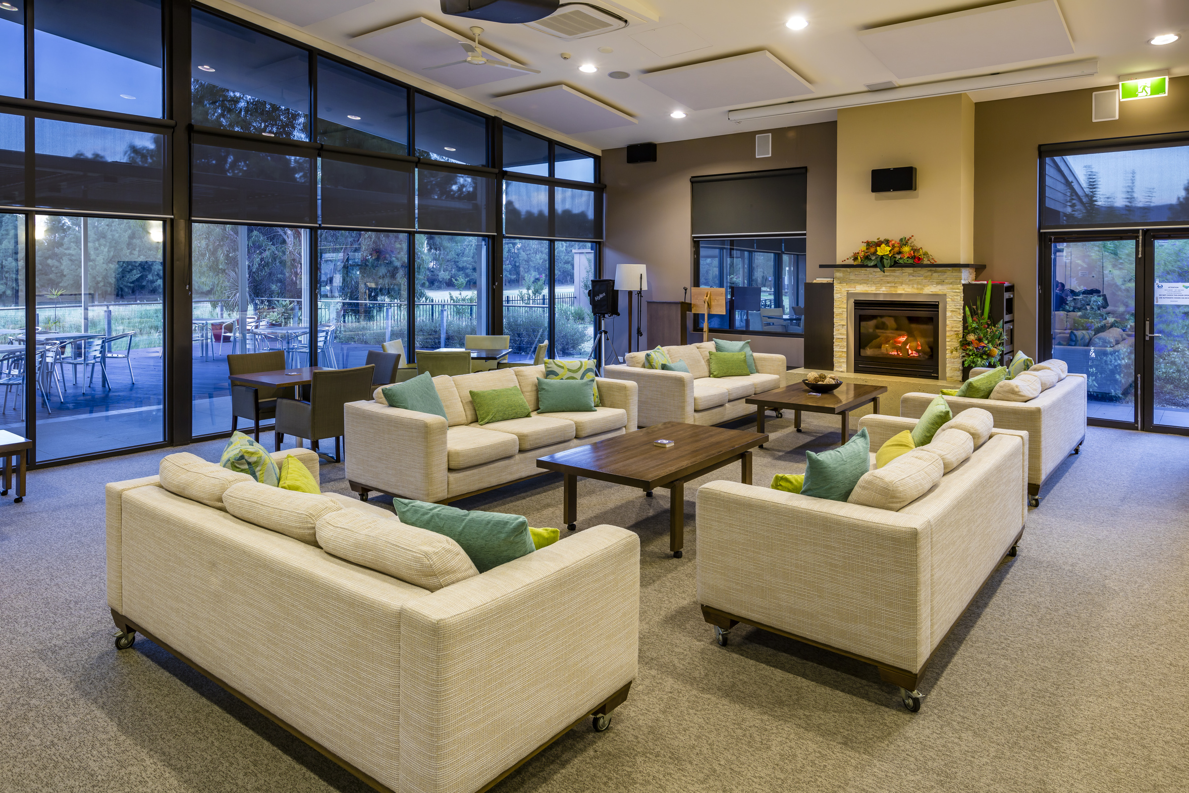 Waterford Park lounge area with fireplace next to outdoor terrace