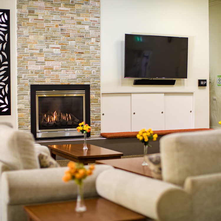 Fiddlers Green lounge area with lots of seating a fireplace and big television