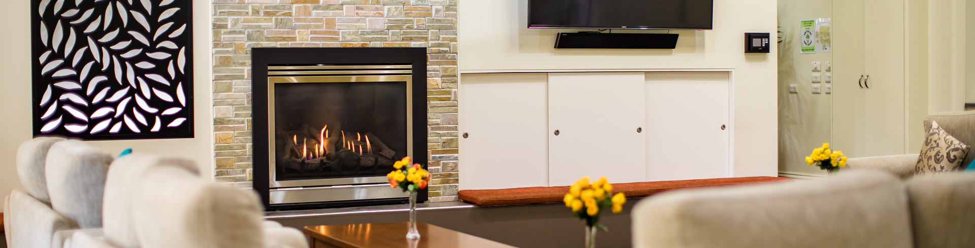 Fiddlers Green lounge area with lots of seating a fireplace and big television