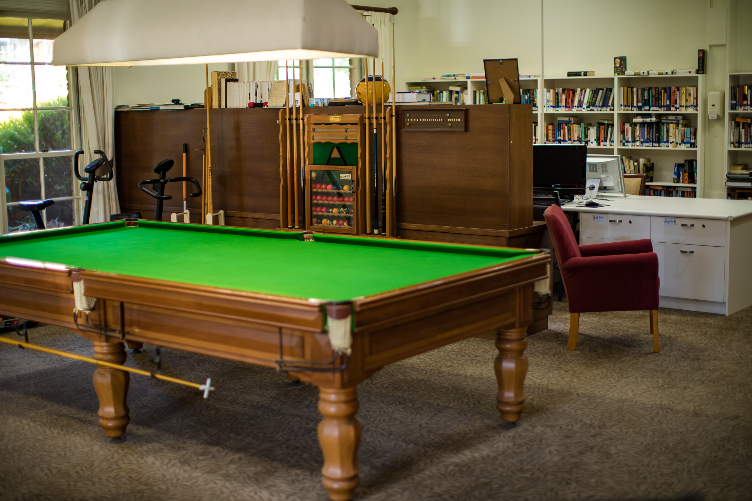 Fiddlers Green pool table with library in background
