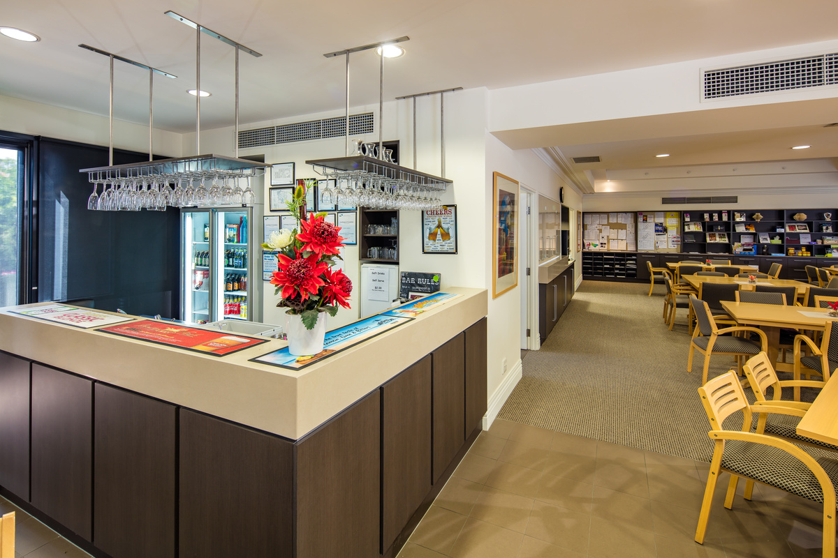Windsor Park bar area with stocked drinks fridge and seating