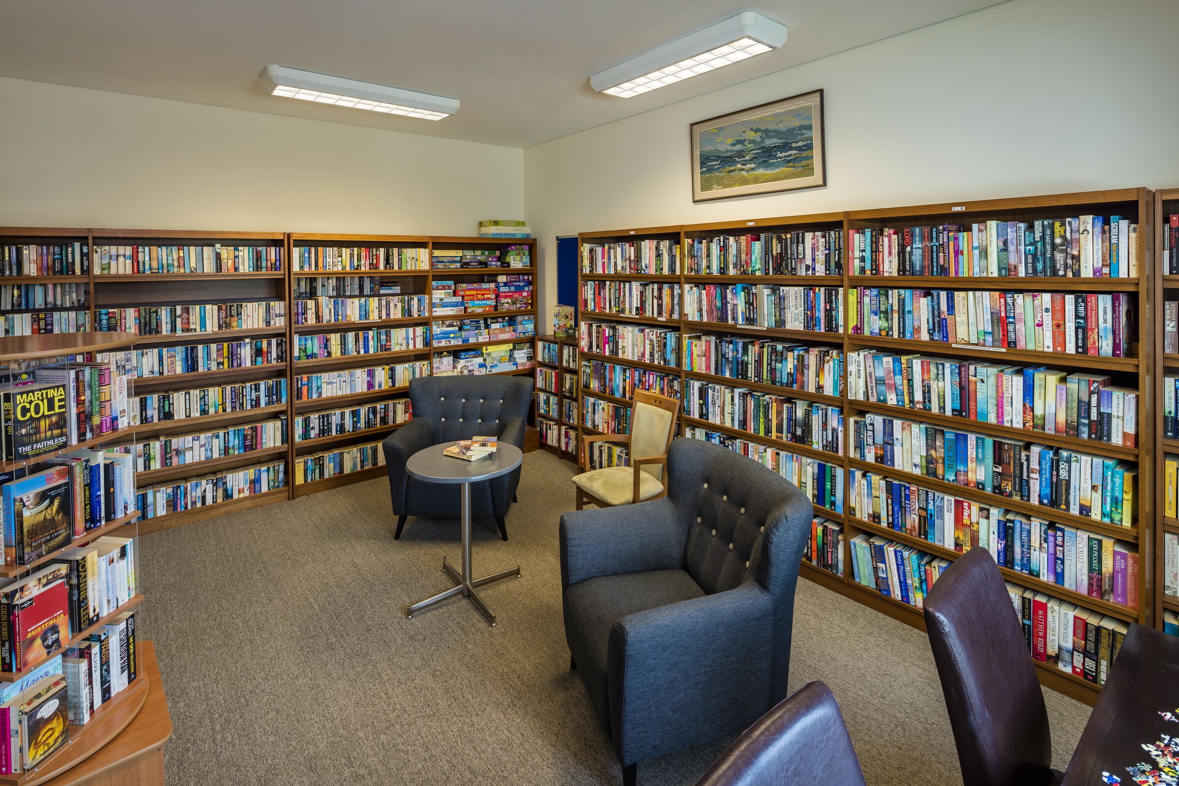 Waterford Park library room with well stocked bookcases and seating