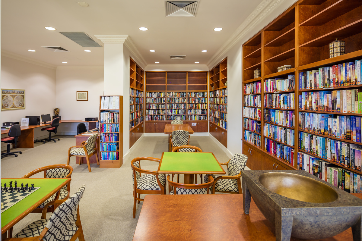 Waterford Valley Lakes library and computer room with well stocked bookcases and seating