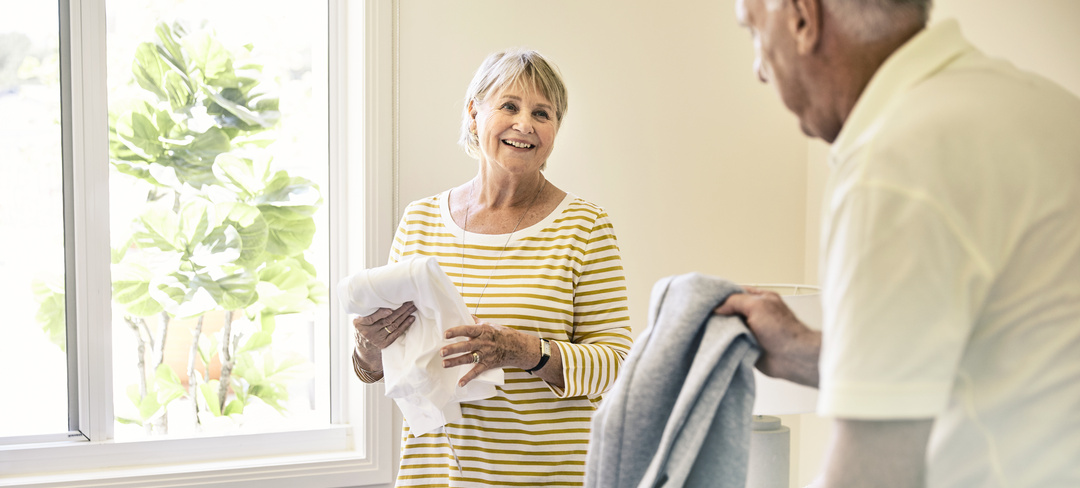 Two retirement village residents packing their luggage for a winter getaway