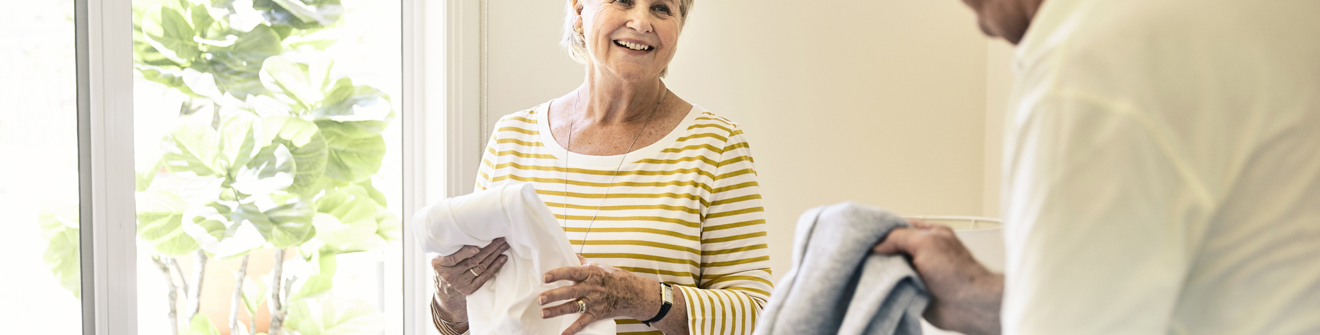 Two retirement village residents packing their luggage for a winter getaway