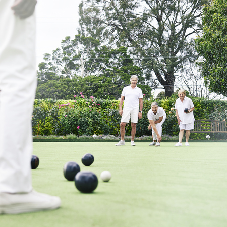 Male and female residents playing lawn bowls