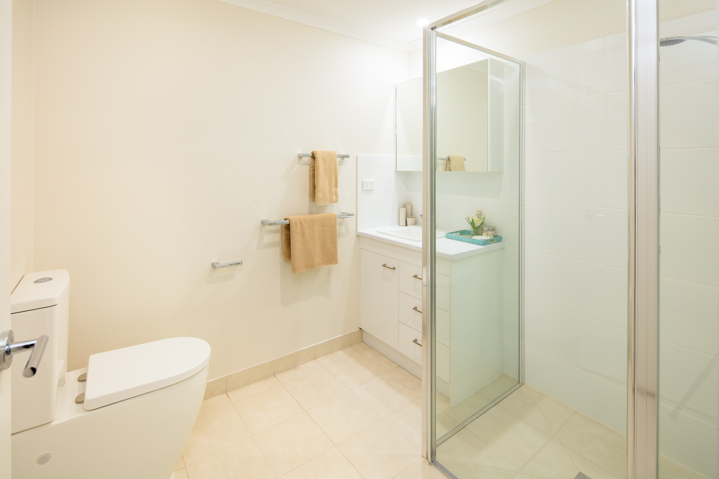 Meadowvale Village modern bathroom with glass shower, toilet, sink and medicine cabinet with mirror