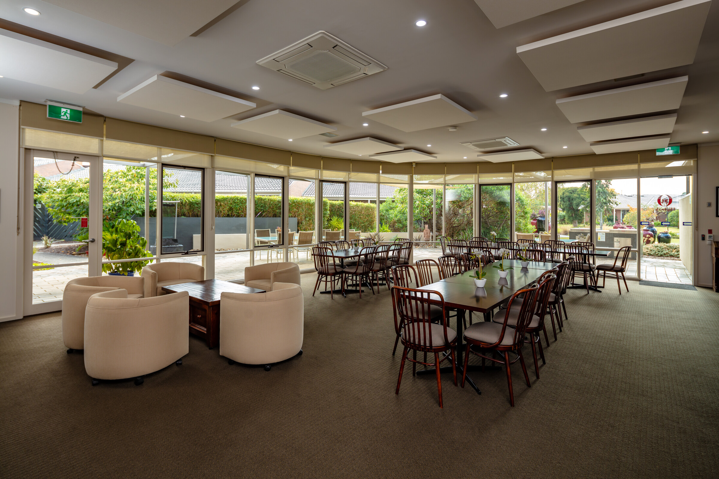 Highvale Village dining room and lounge area with floor to ceiling windows overlooking terrace