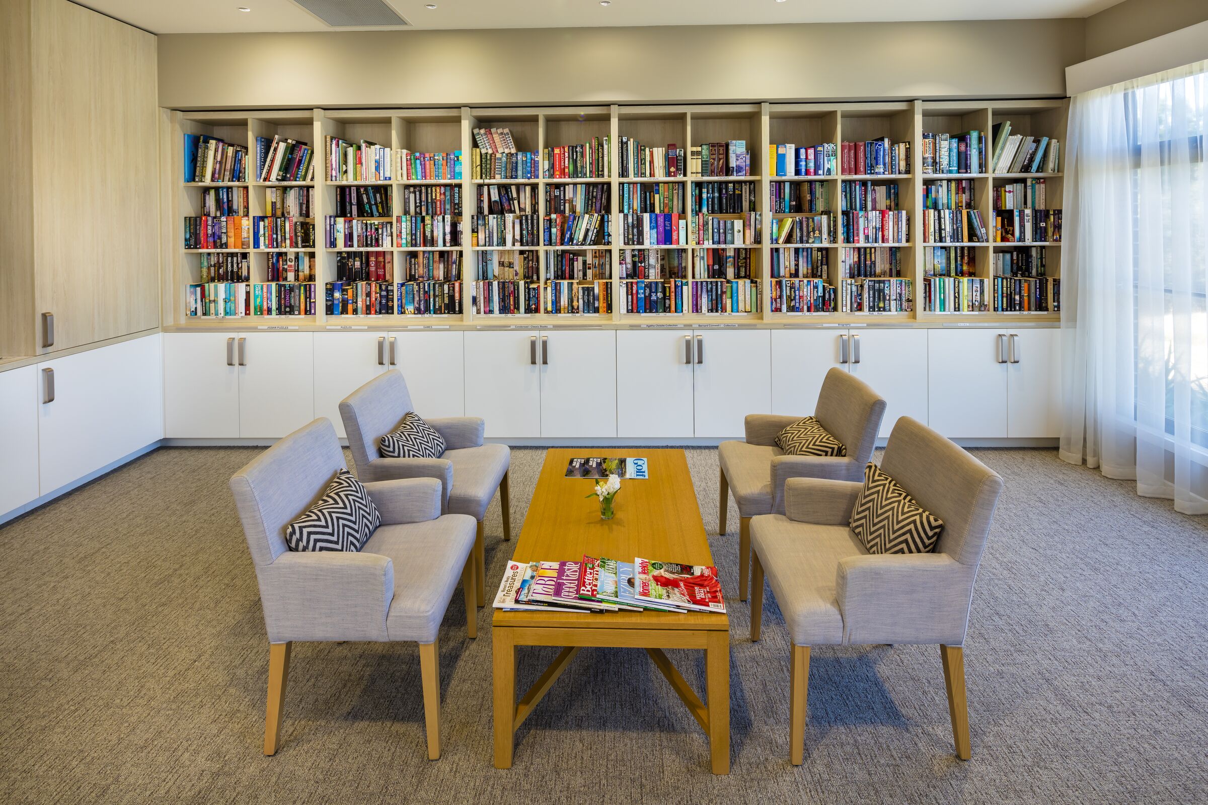 The Links at Waterford library room with well stocked bookcases and seating