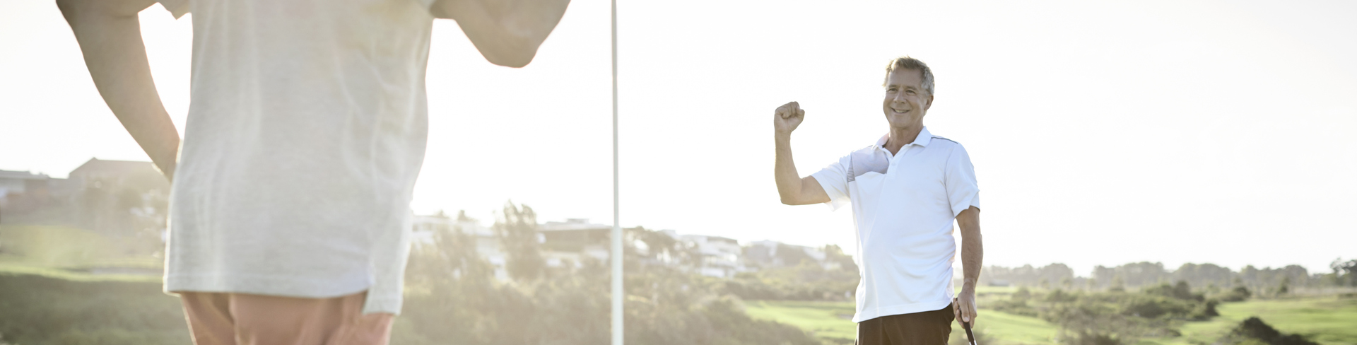 Two senior men playing golf