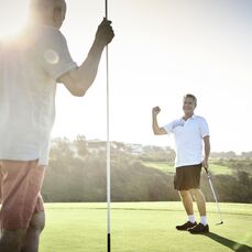 Two senior men playing golf