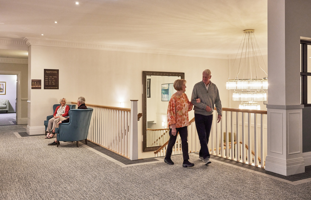 Classic Residences Brighton relaxing area at top of staircase area with huge chandelier