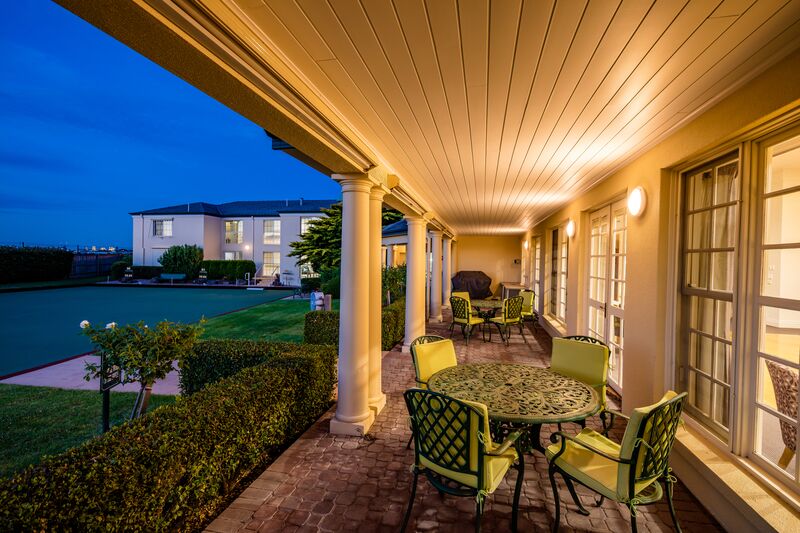 Port Phillip Village covered terrace with seating overlooking bowling green