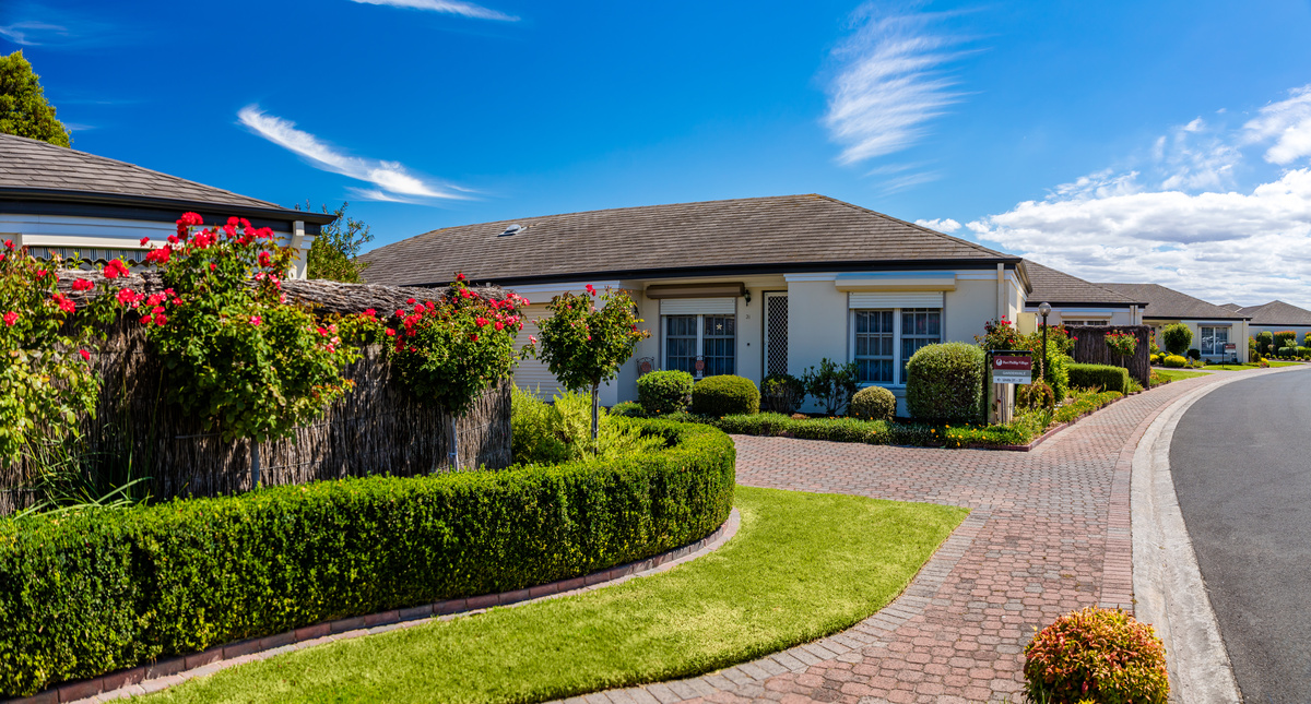 Port Phillip Village street view of road, path, garden and houses