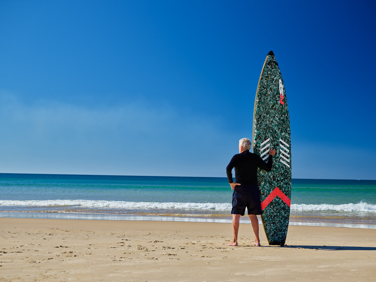 Man standing with paddleboard