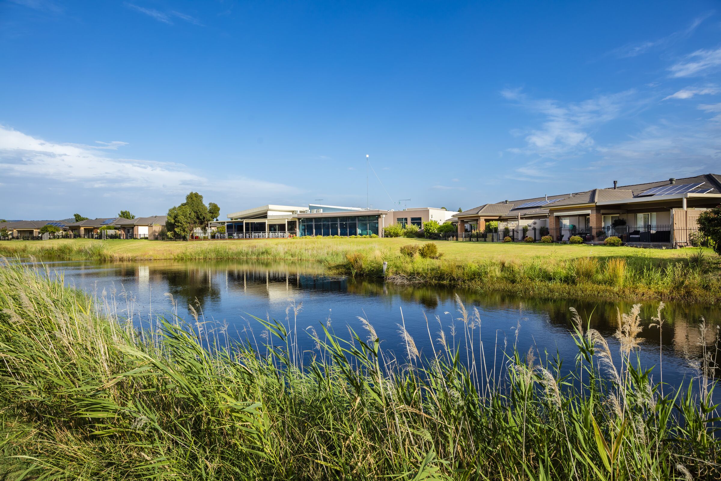 Waterford Park looking towards village buildings over nearby golf lake