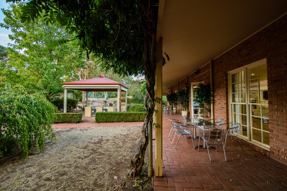 Fiddlers Green covered terrace with seating beside building plus covered barbeques