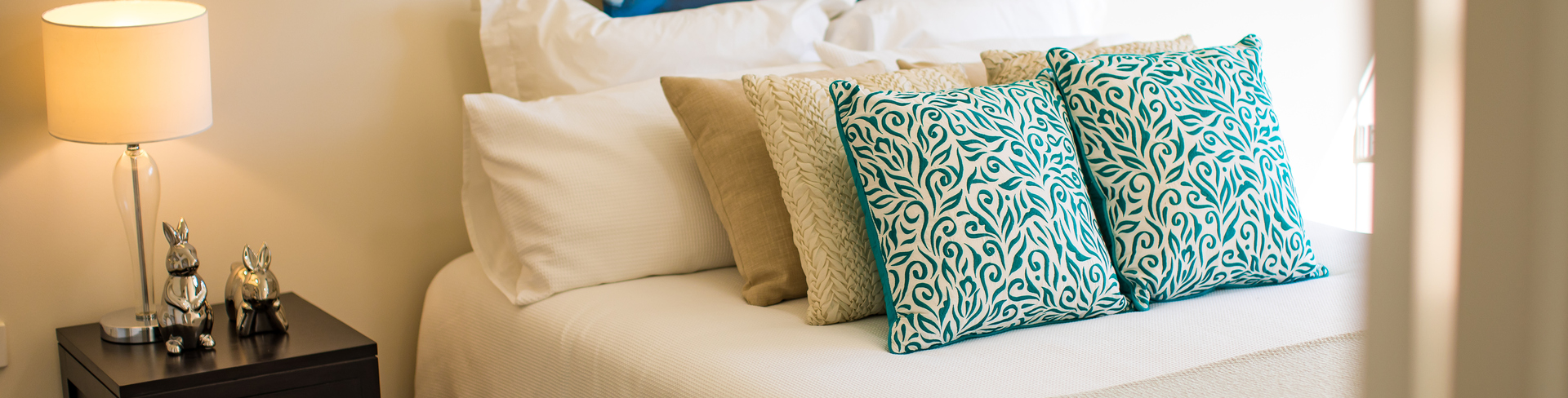 Fiddlers Green bedroom with bed and bedside table and artwork on wall