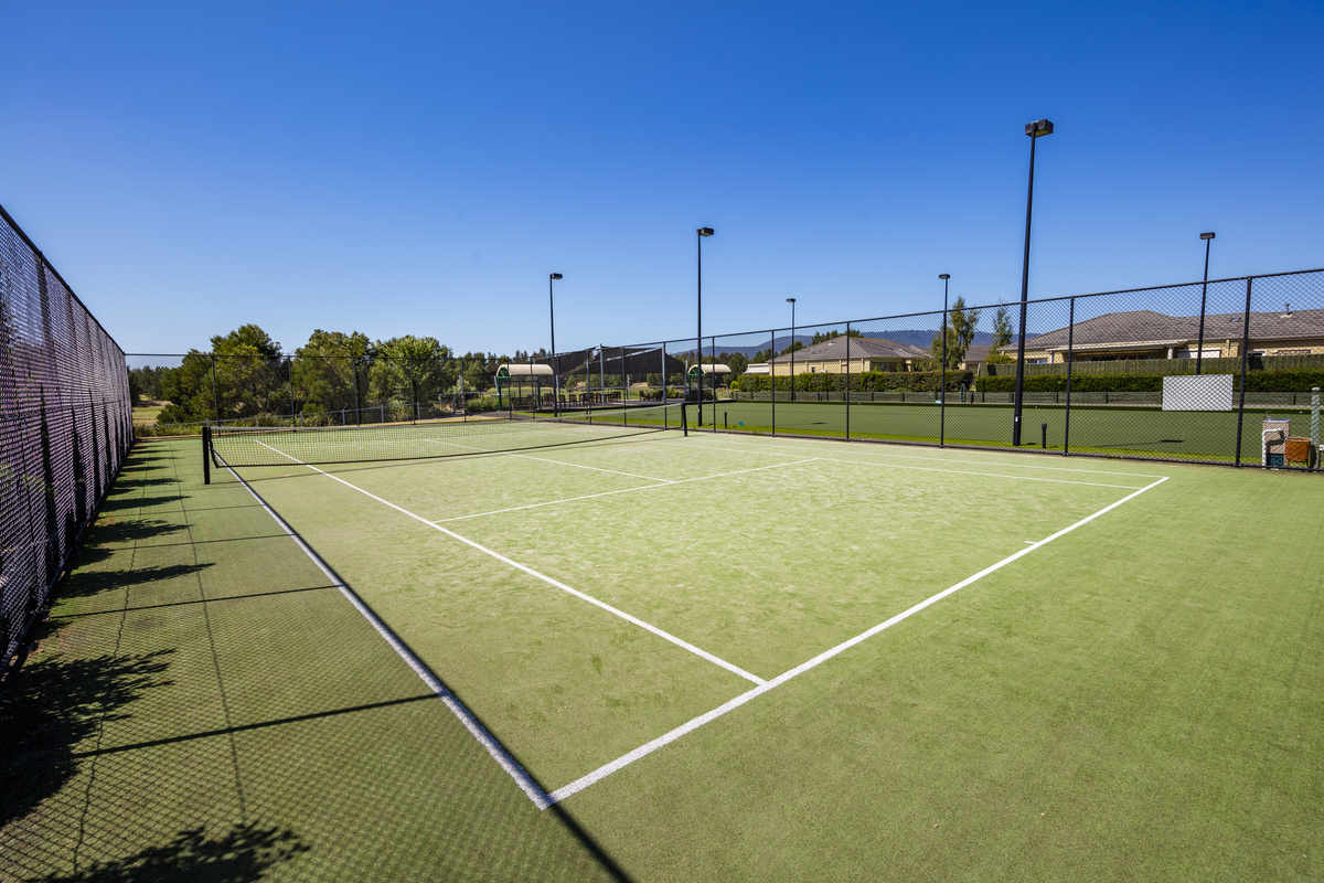 Waterford Valley Lakes grass tennis court next to bowling green