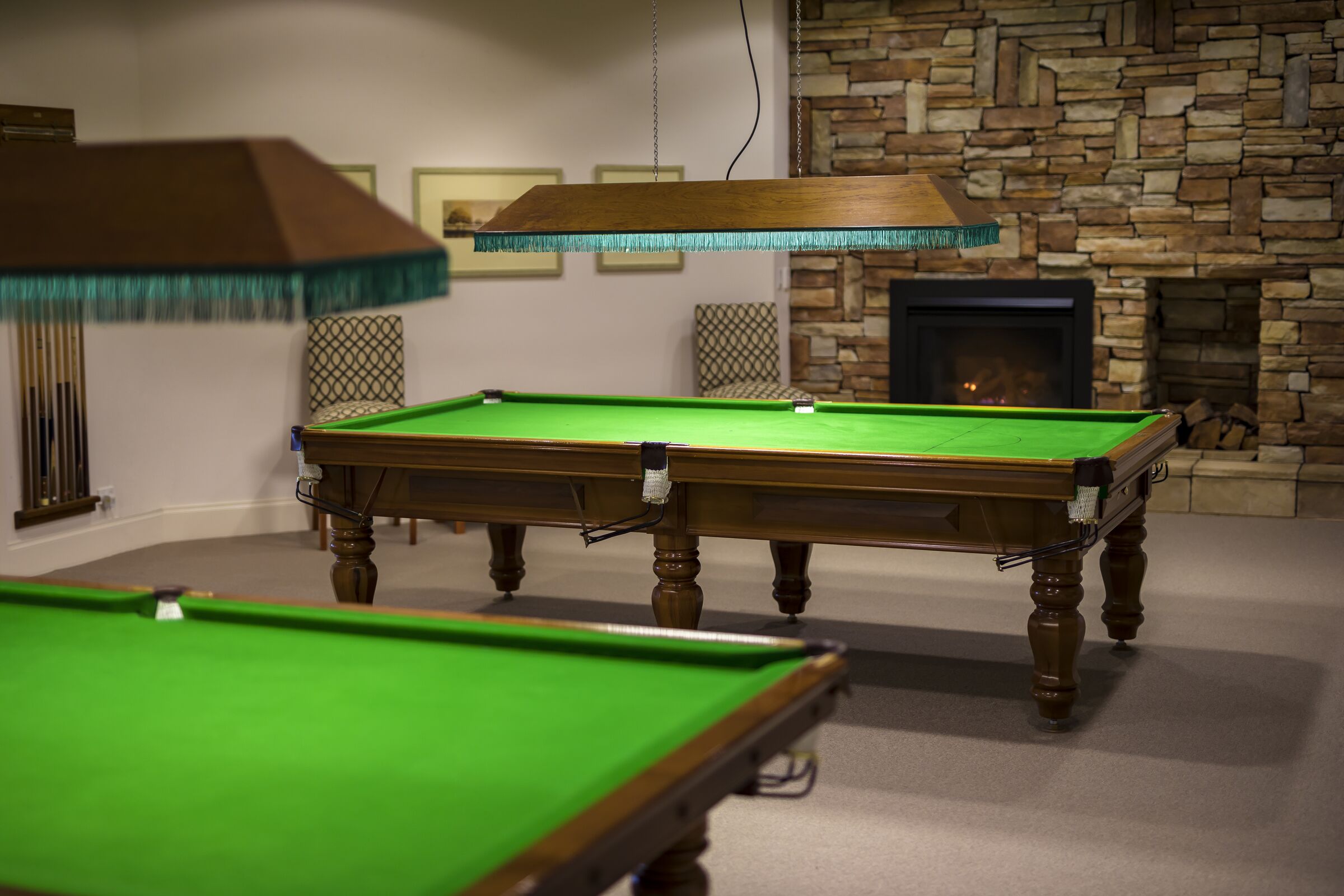 Waterford Valley Lakes room with two pool tables and a fireplace