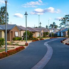 A peaceful street in retirement village Rochford Place with stylish modern villas and lovely streetscape gardens.