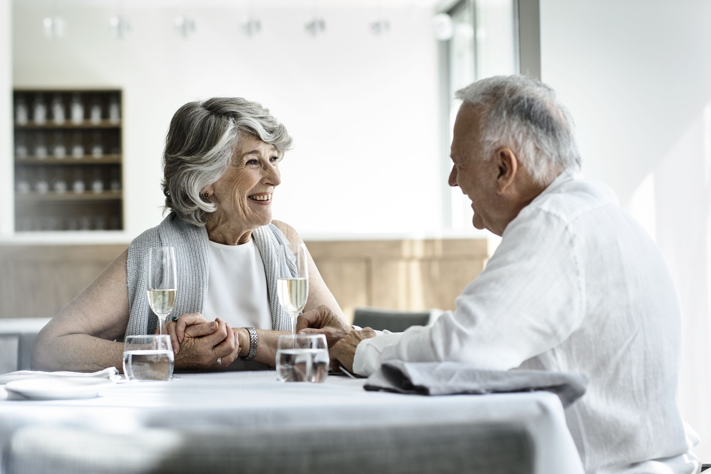 Senior couple having dinner and smiling at each other