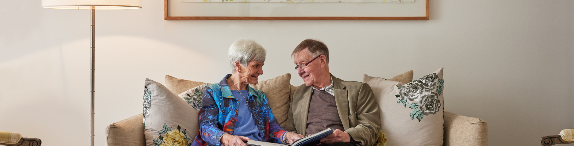 Menzies Malvern couple reading book together on couch