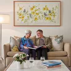 Menzies Malvern couple reading book together on couch