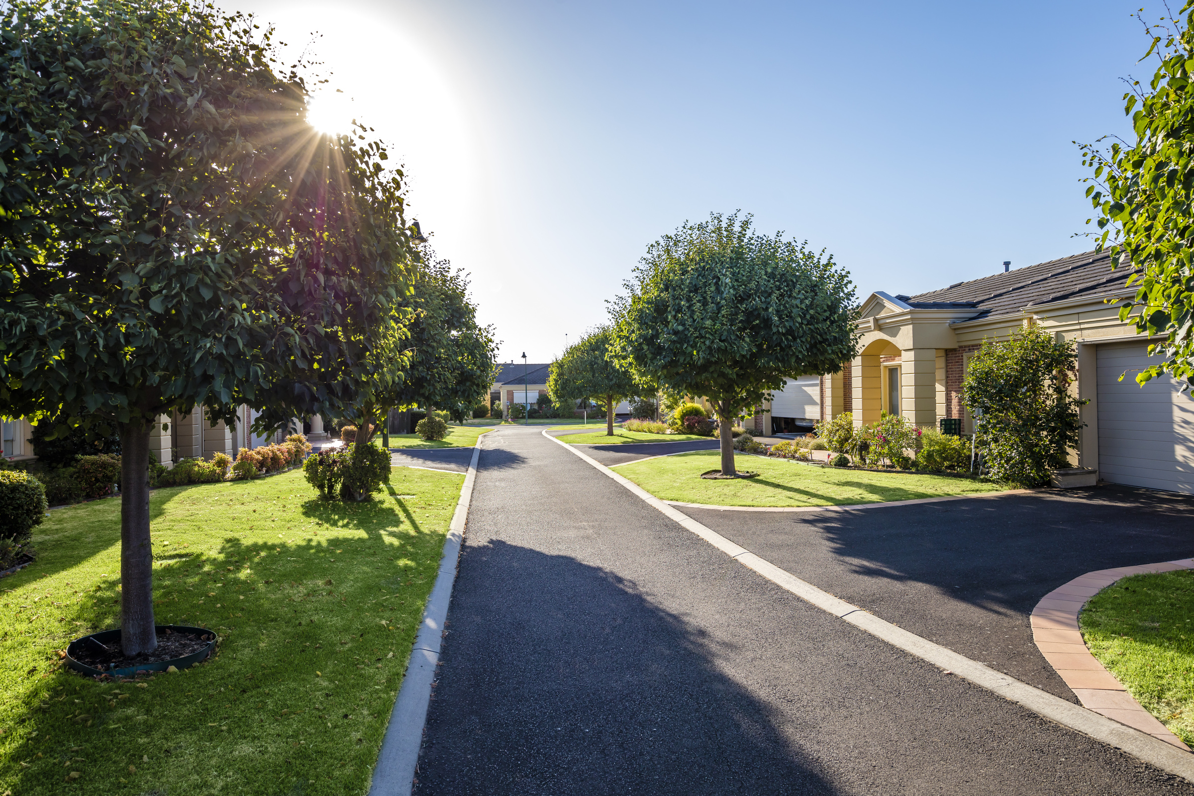 Waterford Valley Lakes village roadway lined with homes, trees, gardens and lawns