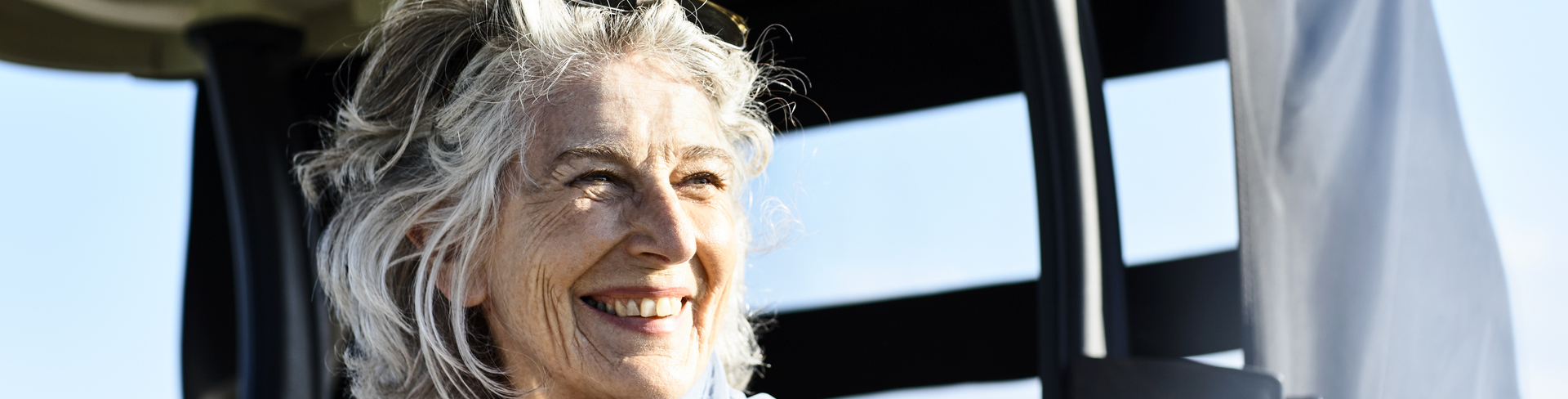 Senior woman on a golf cart smiling